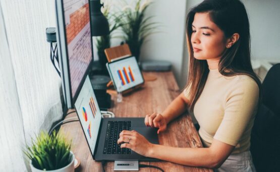 Femme travaillant devant un ordinateur et regardant ses statistiques